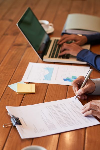 Close-up image of entrepreneur checking document before signing